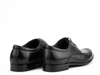 A pair of classic leather elegant men's shoes isolated white background. Groom's stylish black shoes. Isolated object close up on white background.