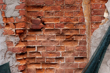 Old red brick wall with mesh.