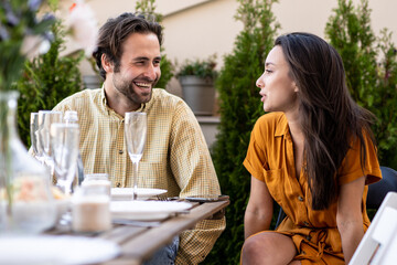 Family and friends celebrating at dinner on a rooftop terrace