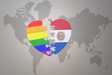 puzzle heart with the rainbow gay flag and paraguay on a world map background. Concept.