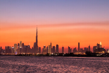 Fototapeta na wymiar Dubai Creek Harbor sunset with the image of Dubai Downtown, October 2021