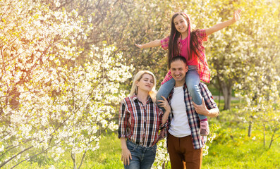 Happy young family spending time together outside in green nature
