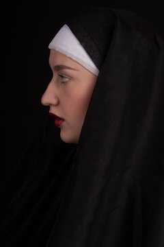 Vertical Shot Profile View Of A Young Sexy Nun Girl. Isoalted On Black Background.