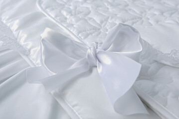 Delicate white bow close up. Textile fabric decoration background