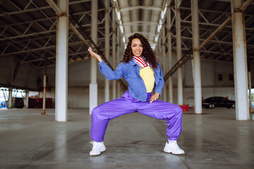 Young  woman - dancer dancing  in the underpass. Sport, dancing and urban culture concept.