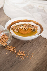 Delicious and healthy smoothie bowl on rustic wooden background.
