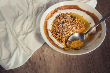 Delicious and healthy smoothie bowl on rustic wooden background. Top view and copy space.
