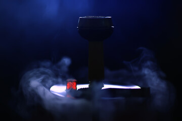 hookah smoke bowl with tobacco dark arabic style background
