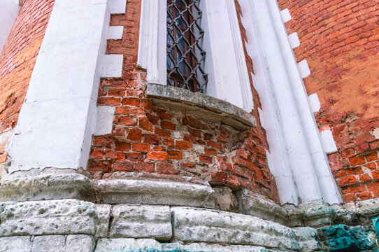 Destroyed Brickwork As A Result Of External Environmental Factors. The Base Of The Ancient Building Is Made Of Light-colored Sandstone.