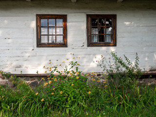 Fototapeta na wymiar A window in a white wooden hut, Traditional wooden hut, Wooden traditional window, Poland