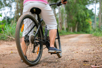 senior business woman, female, ride or bike mountain bicycle in country park near home town for healthy exercise in summer weekend