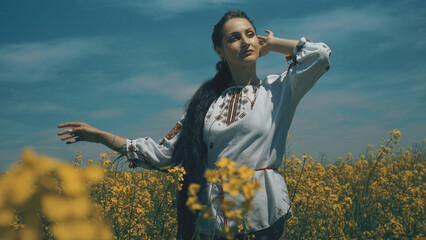 Ukrainian woman in ethnic dress in the field