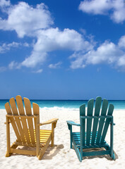 Wooden lounge chairs on white sand beach