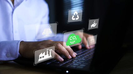 Businessman working with reduce CO2 emission concept with icons, global warming such as reforest...