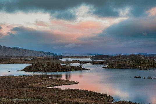 Beautiful vibrant Winter sunrise landscape image across Rannoch Moor in Scottish Highlands