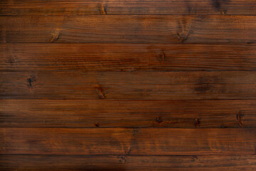 Close-up of textured brown wooden board.