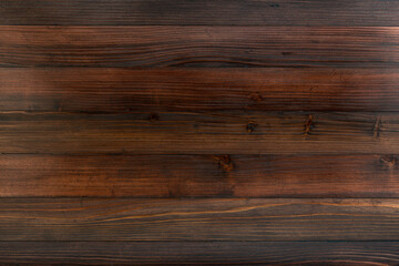 Close-up of textured brown wooden board.