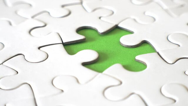 Rotating shot of a missing piece puzzle to completion. Strategy and business goals concepts
