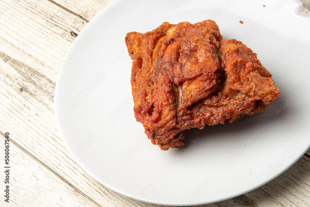 Wall mural Asian street food fried chicken in a plate, white, delicious onion, on background.