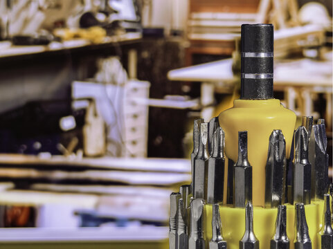Small set of screwdriver against the blurred capenter workshop background. Small toolkit, screwdriver.