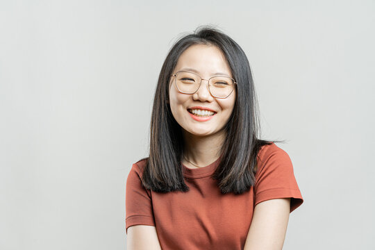 Portrait Of A Korean Girl On A Gray Background.