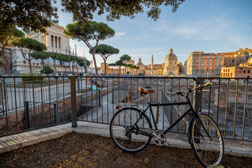 Scenic view on ruins of Roman Forum with bicycle parked in front. Rome cityscape on sunset. Concept...