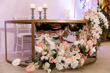 Newlyweds table with festive floral decor on wedding with natural flowers