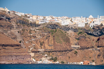 View from the sea of Athinios ferry port of the island of Santorini and the village of Thira