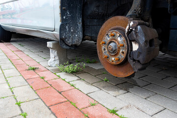 Rusty discs brake  on an abandoned car. Object illuminated with soft, natural light
