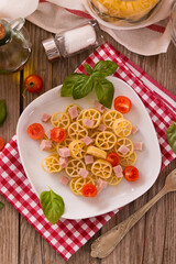 Ruote pasta with tomato and ham.