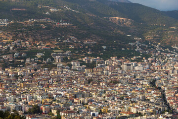 Fototapeta na wymiar Turkey, Alanya, 30.08.2021: The city of Alanya (Turkey) from a bird's eye view. Densely populated city from above. Travel to Turkey. Türkiye 