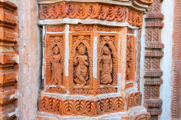 Lord Kirishna with Radha , depicting eternal love - Terracotta art works on the temple walls of Lalji temple of Kalna, West Bengal, India - It is one of oldest temples of lord Krishna (a Hindu God).