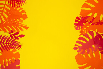 red and orange jungle leaves on the left and right of the yellow background, in the middle copy...