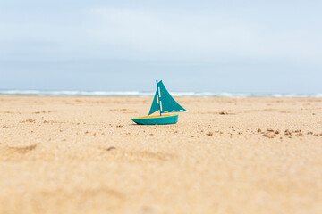 toy boat on the beach