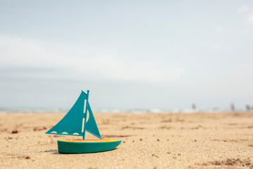 toy boat on the beach