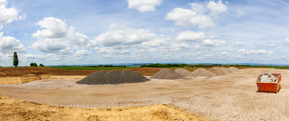 entrance construction site, driveway of building site. Pile of sand and Gravel for construction....
