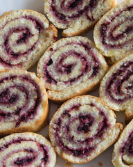 Pieces of biscuit roulade roll with fruit jam, close-up