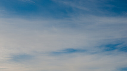 Naklejka na ściany i meble Blurred white clouds on blue sky..