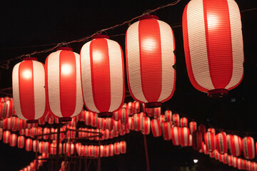 Japanese red paper lanterns hanging for traditional summer festival at night