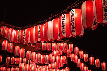 Japanese red paper lanterns hanging for traditional summer festival at night