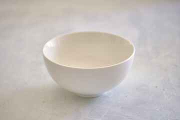 White ceramic plate with a bowl on a concrete table