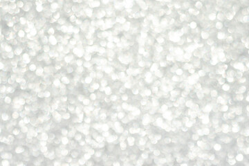 Abstract white bokeh background, defocused blurry sparkles.