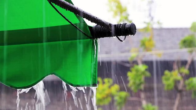 Extreme monsoon rain flooded roads water drops Koh Samui Thailand.