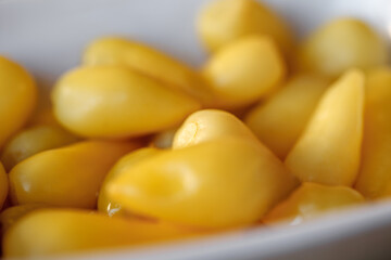 Peppers yellow and spicy, the snack is spicy, in bulk, selective focus.