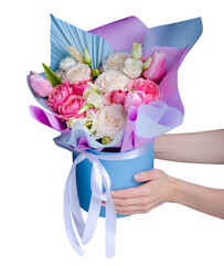 Round gift box with flowers in hand on white background isolation