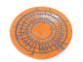 Mid-century modern pottery - wall plate with orange glaze and black stripes