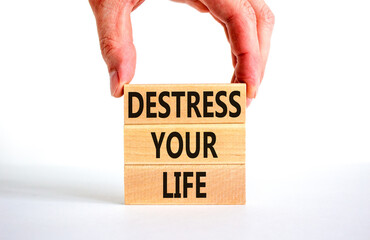 Destress your life symbol. Concept words Destress your life on wooden blocks. Doctor hand. Beautiful white table white background. Psychological business and destress your life concept. Copy space.