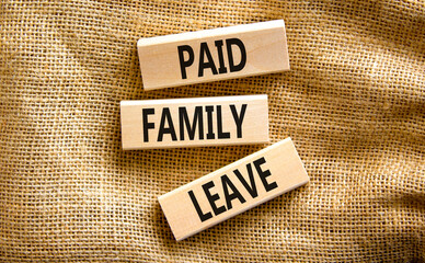 Paid family leave symbol. Concept words Paid family leave on wooden blocks. Beautiful canvas table canvas background. Business medical and paid family leave concept. Copy space.