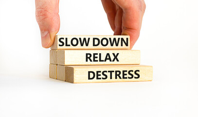 Destress symbol. Concept words Slow down Relax Destress on wooden blocks. Beautiful white table...
