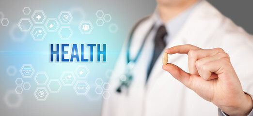 Obraz premium Close-up of a doctor giving you a pill